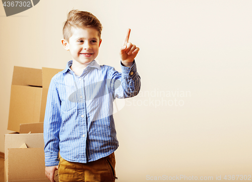 Image of little cute boy in empty room, remoove to new house. home alone,