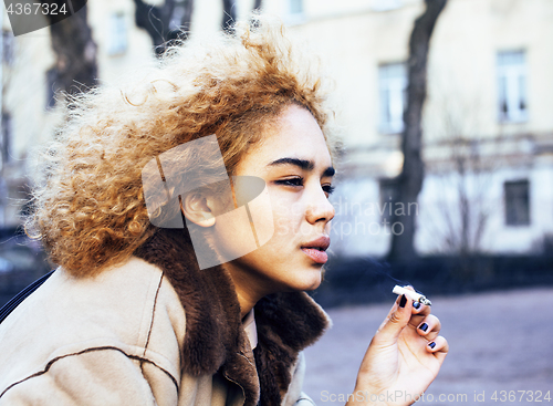 Image of young pretty girl teenage outside smoking cigarette close up, lo