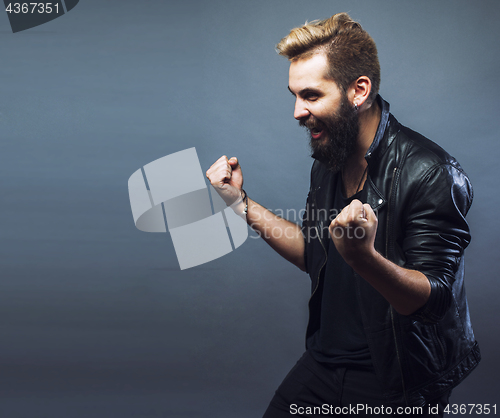 Image of portrait of young bearded hipster guy smiling on gray background close up, lifestyle people concept 