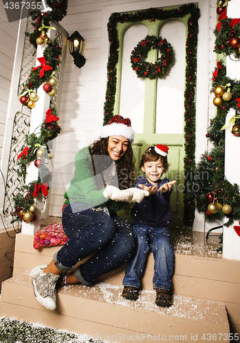 Image of happy smiling family on Christmas at house with gifts, young mot