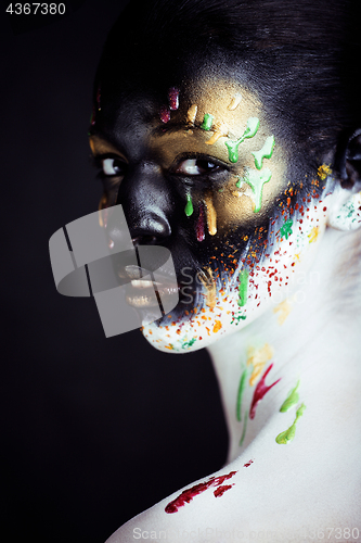 Image of woman with creative makeup closeup like drops of colors, facepai