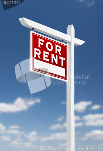 Image of Left Facing For Rent Real Estate Sign on a Blue Sky with Clouds.