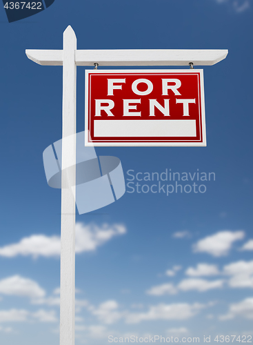 Image of Right Facing For Rent Real Estate Sign on a Blue Sky with Clouds