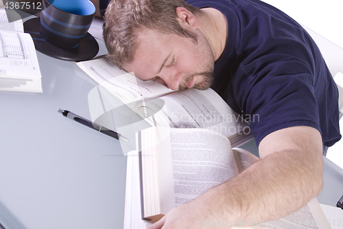 Image of College Student Sleeping on his Desk