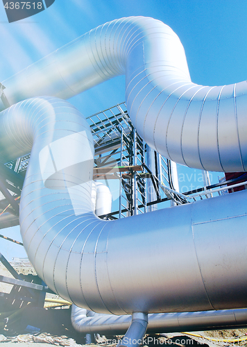 Image of Industrial zone, Steel pipelines and valves against blue sky