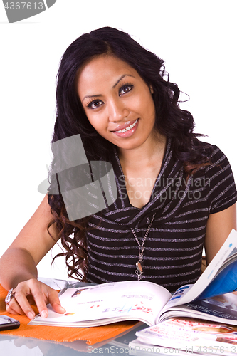 Image of Beautiful Woman Reading a Magazine