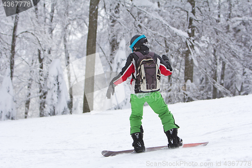 Image of Winter sport snowboarder at ski slopeand alps mountains landscap