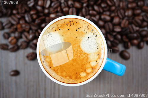 Image of fresh espresso cup on table, view from above