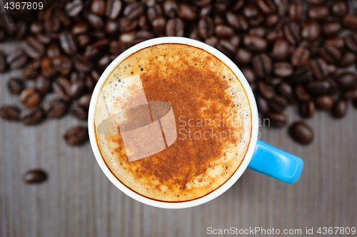 Image of fresh espresso cup with cinnamon, view from above