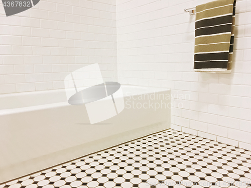 Image of New bathroom with black and white ceramic tile decor