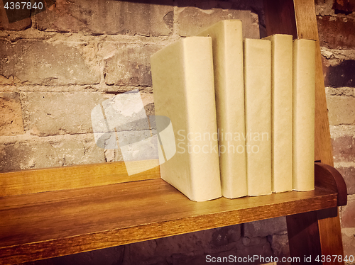 Image of Books in paper covers on a wooden shelf