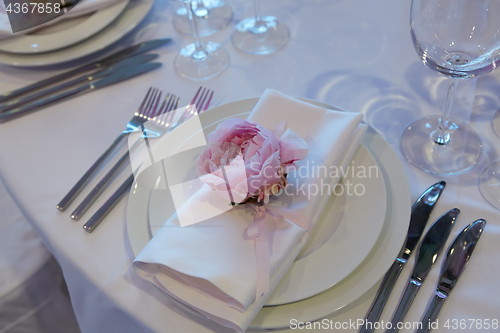 Image of Spring table settings with fresh flower, napkin and silverware. Holidays background. Selective Focus.