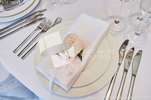 Image of Spring table settings with fresh flower, napkin and silverware. Holidays background. Selective Focus.