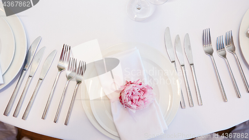 Image of Spring table settings with fresh flower, napkin and silverware. Holidays background. Selective Focus.