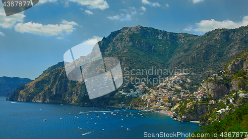 Image of One of the best resorts of Italy with old colorful villas on the steep slope, nice beach, numerous yachts and boats in harbor and medieval towers along the coast, Positano.