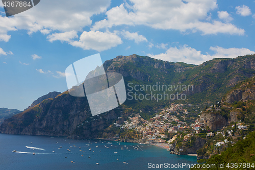 Image of One of the best resorts of Italy with old colorful villas on the steep slope, nice beach, numerous yachts and boats in harbor and medieval towers along the coast, Positano.