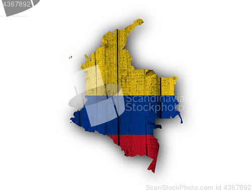 Image of Map and flag of Colombia on weathered wood