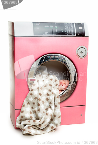 Image of Portrait of an newborn in a washing machine