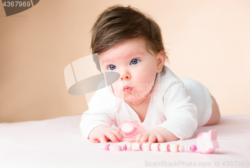 Image of Bright blue eyed 6 month old baby girl