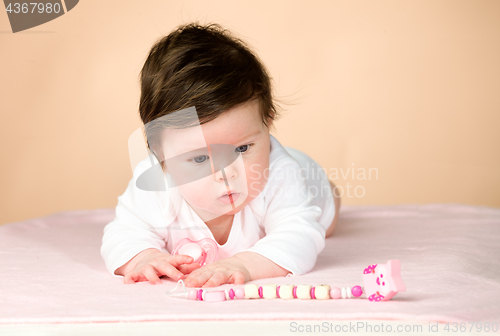 Image of Bright blue eyed 6 month old baby girl