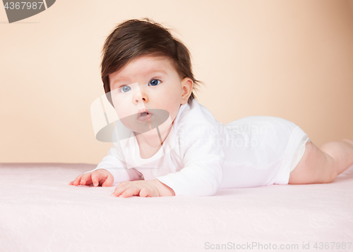 Image of Bright blue eyed 6 month old baby girl