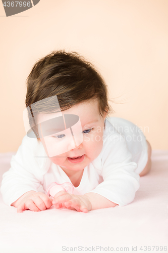 Image of Bright blue eyed 6 month old baby girl