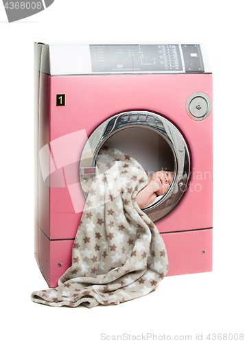 Image of Portrait of an newborn in a washing machine