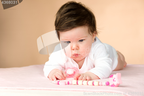 Image of Bright blue eyed 6 month old baby girl