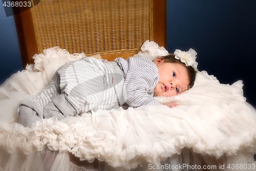 Image of Newborn baby girl with sleeping on a wooden chair