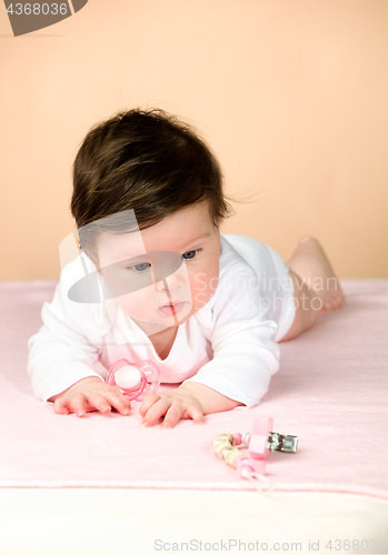 Image of Bright blue eyed 6 month old baby girl