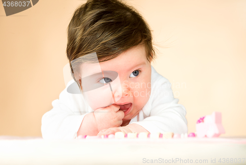 Image of Bright blue eyed 6 month old baby girl