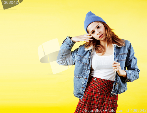 Image of lifestyle people concept: pretty young school teenage girl having fun happy smiling on yellow background 