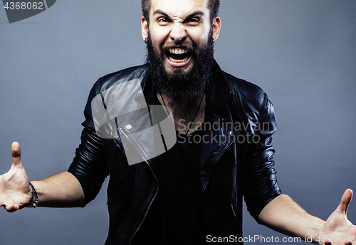 Image of portrait of young bearded hipster guy on gray dark background close up, brutal modern man, lifestyle people concept 