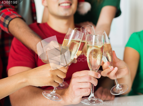 Image of friends clinking glasses of champagne at party