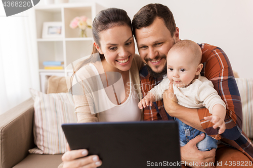 Image of mother, father and baby with tablet pc at home