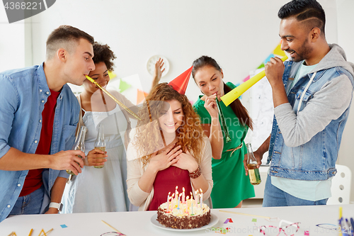 Image of happy coworkers with cake at office birthday party