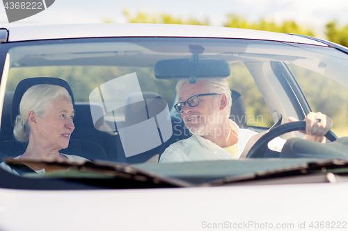 Image of happy senior couple driving in car