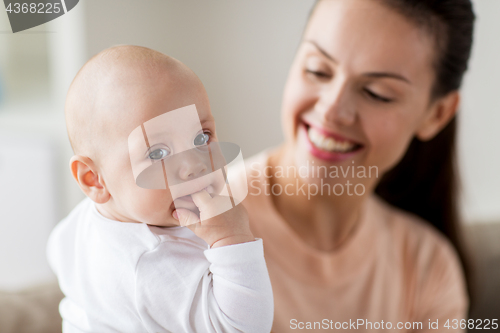 Image of happy mother with little baby boy at home