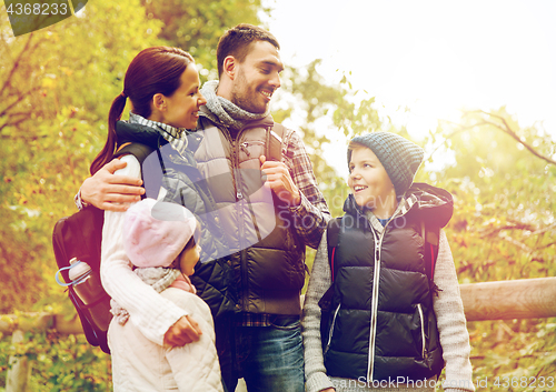 Image of happy family with backpacks hiking