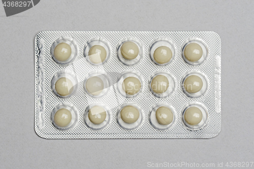 Image of Pills in a pack on gray paper background