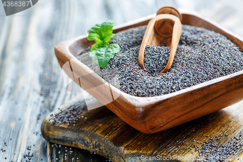 Image of Poppy seeds in a wooden bowl.