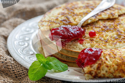 Image of Delicious pancakes with berry jam.