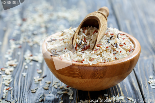 Image of Wooden scoop in a bowl with a mixture of four types of rice.