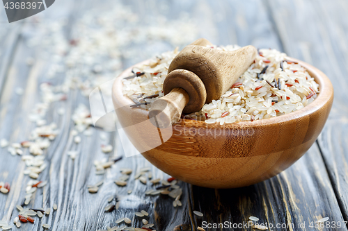 Image of Scoop into a bowl with mixture of four types of rice closeup.