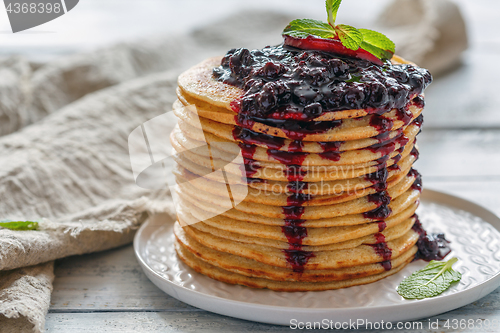Image of Stack of pancakes with berry sauce.