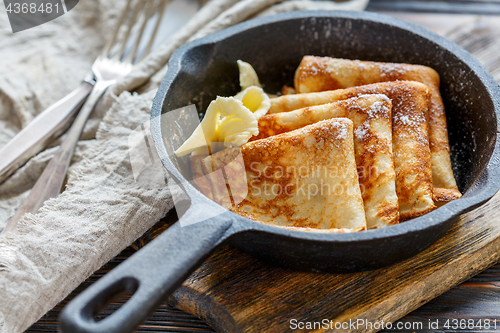 Image of Crepes with butter and powdered sugar.