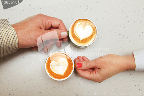 Image of lovers with cups of coffee