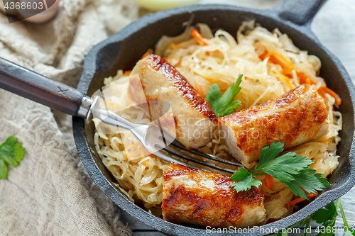 Image of Steamed sauerkraut with grilled sausages.