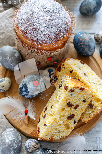 Image of Easter cake and eggs on a wooden stand.