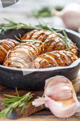 Image of Potatoes in their skins baked with rosemary.